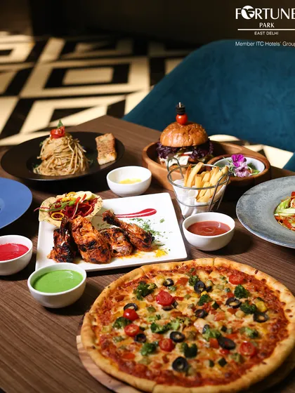 A feast that brings everyone to the table. Our menu at Zodiac features a world of flavors, from authentic Indian curries and kebabs to Italian pastas and wood-fired pizzas, ensuring there is something for every palate.