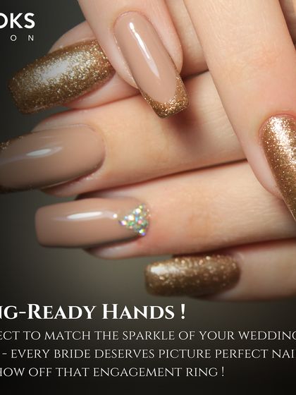 Ring-ready hands are a must for every bride. This image showcases a beautiful bridal manicure with nude polish and gold glitter accents, perfect for showing off that engagement ring.