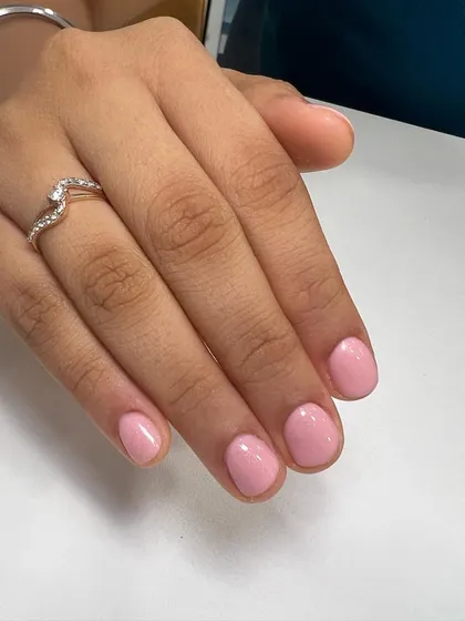 Another look at the flawless results of a Russian manicure. The cuticle area is perfectly clean, allowing the baby pink polish to be applied neatly for longer-lasting wear.