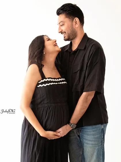 A candid, laughing moment between the expecting couple. My minimalist white backdrop sessions allow your joy and connection to be the main focus.