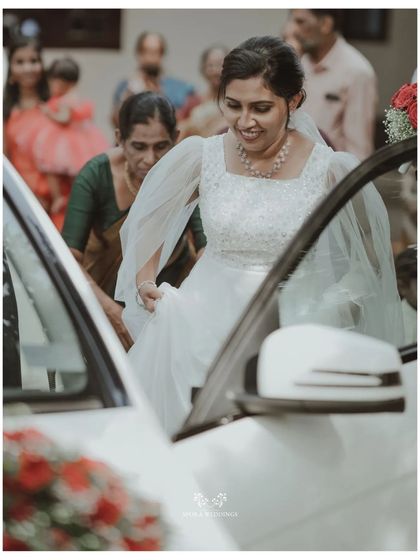 The bride stepping out of her wedding car, a moment of transition and excitement captured beautifully.
