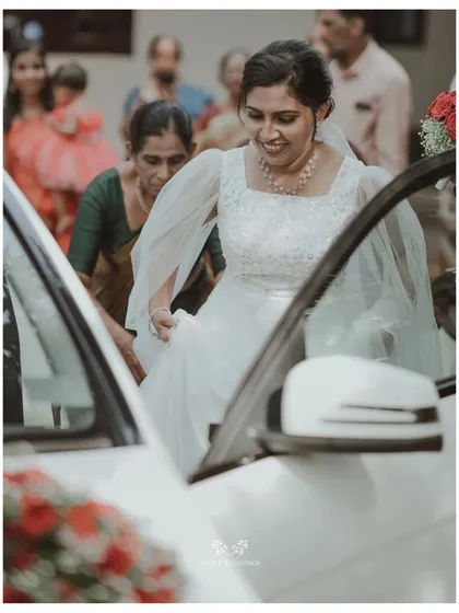 The bride stepping out of her wedding car, a moment of transition and excitement captured beautifully.