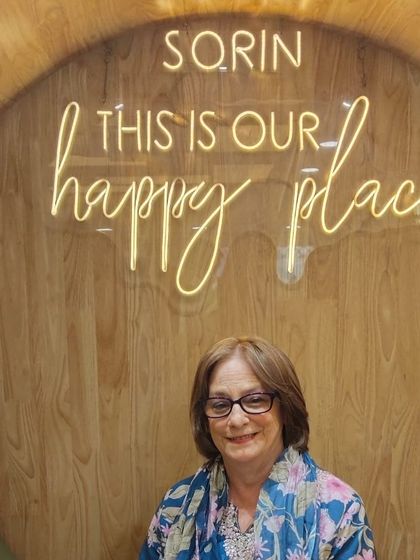 Posing proudly in our "happy place" with her new hair. The colour and cut work together to create a polished and sophisticated style.