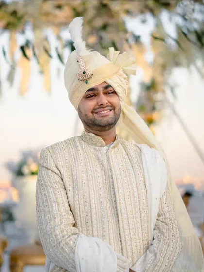 A close-up of the groom, his smile radiating warmth and happiness.