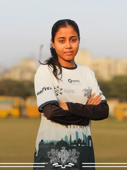 The look of a leader. This player's strong stance and crossed arms show her readiness to lead.
