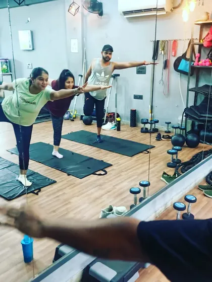 A view from the mirror of my students practicing a balancing pose. The reflection helps them check their alignment and posture as I guide them.