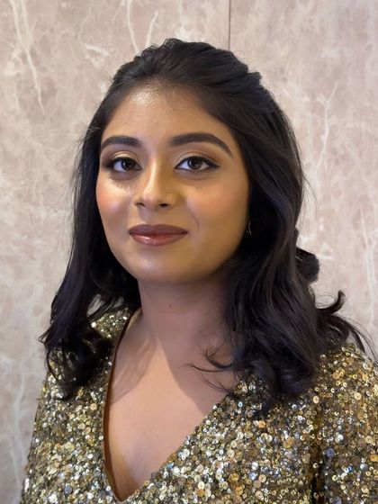 A portrait showing the full face of this glamorous party makeup. The eyes are the star of the show, with a beautiful gold shimmer.