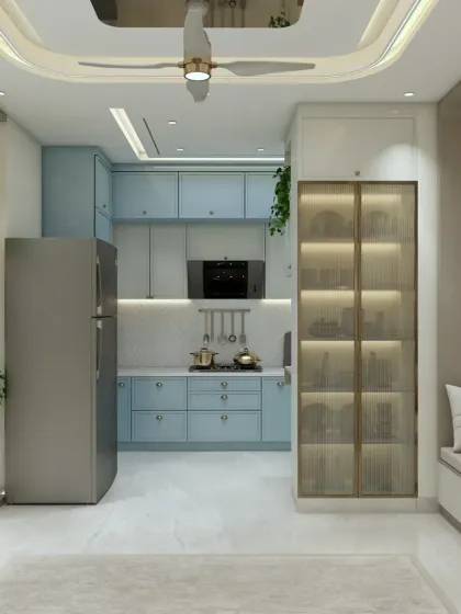 A beautiful pastel blue kitchen that feels fresh and inviting. The design includes a mix of closed and glass-fronted cabinets, as well as a cozy window seat.