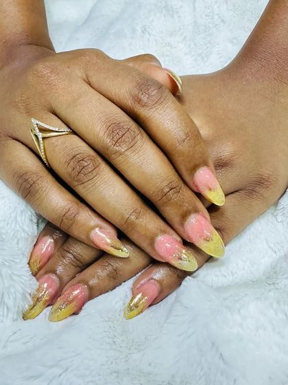 A unique combination of pink and yellow with gold foil flakes embedded within the nail.