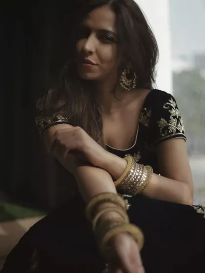 This portrait uses shadows and a seated pose to create a feeling of quiet confidence. The focus is on her expression and the beautiful details of her ethnic wear, showing how mood and style can be conveyed through posture and light.