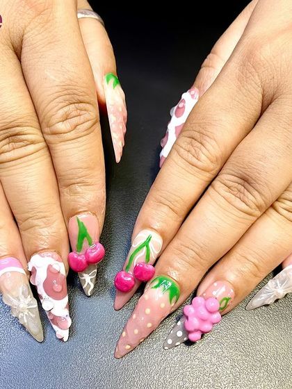 A fun and fruity set of nails with 3D cherries, grapes, and other fruits. This playful design shows the versatility of 3D nail art.