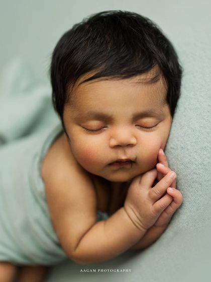 A closer crop of this pose, focusing on the baby's serene face and tiny hands. The simplicity of the setup keeps all the attention on your perfect little one.