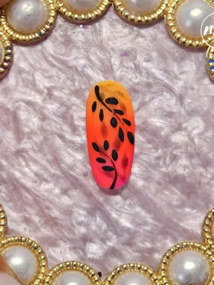 A beautiful ombre nail with a contrasting black leaf silhouette, painted by a student. This shows great control over blending and line work.