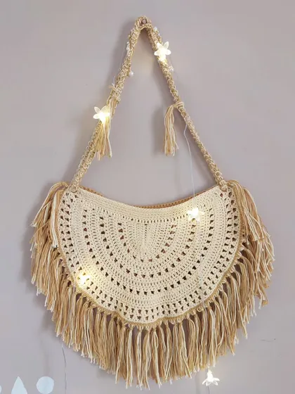 Another view of the Callaia Bag, showing the full length of the fringe and the braided strap.