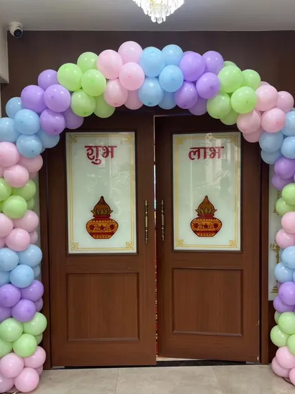 A classic pastel balloon arch framing a doorway. This is a great way to welcome guests and set the party mood right from the entrance.