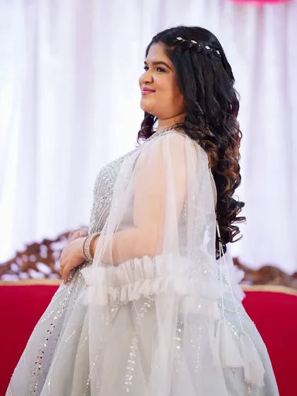 Another angle showing the beautiful hairstyle and the delicate cape of her gown.