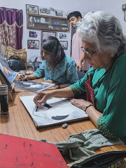 A wider view of our adult students engrossed in their charcoal still life projects. The dedication and focus are palpable.