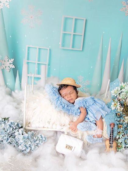 A dreamy winter wonderland for your little snow angel. This setup uses soft blues, fluffy clouds, and sparkling snowflakes to create a magical, serene atmosphere.