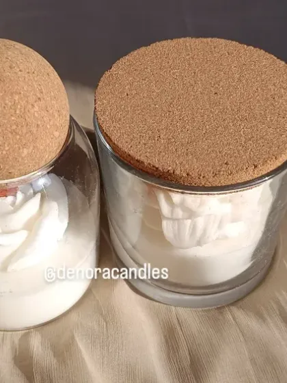 A side-by-side view of the rose and tulip candles in cork-lidded jars.
