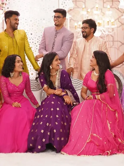 A happy, candid group photo of the couple with their friends, all sharing a laugh. This is what a celebration with your favorite people looks like.