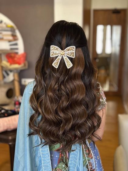 A different take on the bow hairstyle, with the bow placed on soft, voluminous waves. This look is perfect for a Roka or engagement party.