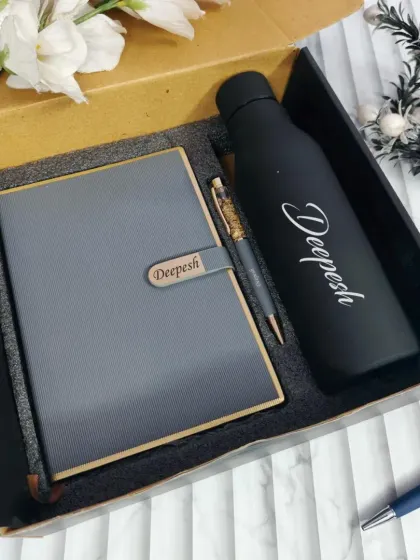 This sleek and professional gift set is perfect for corporate gifting or as a sophisticated birthday present. It features a matching personalized diary and a name-engraved temperature bottle, showing simple elegance.