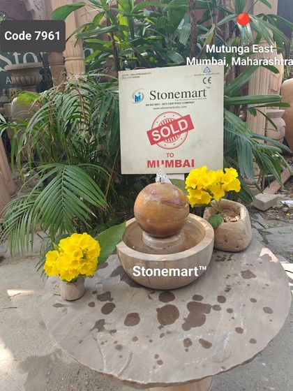 Another view of the 9-inch rainbow sandstone sphere fountain. The natural bands of color in the stone make each piece unique.