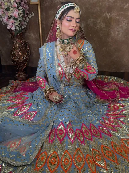 The full skirt of the sky blue lehenga is a work of art. The multi-color peacock feather inspired embroidery is incredibly detailed and eye-catching.