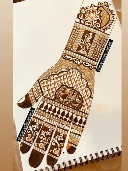 A traditional design featuring an elephant motif, drawn on paper. Practicing on paper is key to mastering symmetry and detail, especially for animal and bird figures.