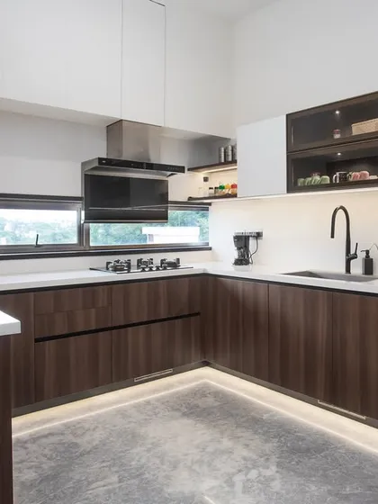 I love combining different textures to create depth. Here, the rich grain of walnut wood on the lower cabinets is balanced by clean, white uppers. The U-shaped layout is a classic for a reason; it makes movement seamless and keeps everything you need within easy reach.
