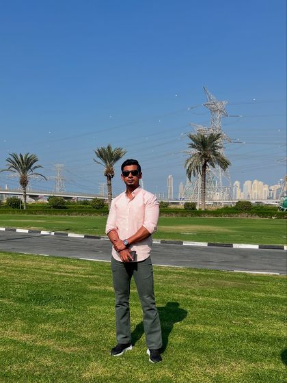 A full-length shot of the grey bootcut jeans in a park setting, highlighting their flattering silhouette and perfect length.