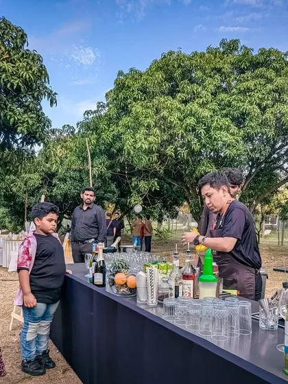 A young boy curiously watches a mixologist at our Doctors' Day event. We believe in creating unique and enjoyable experiences for all members of our community.