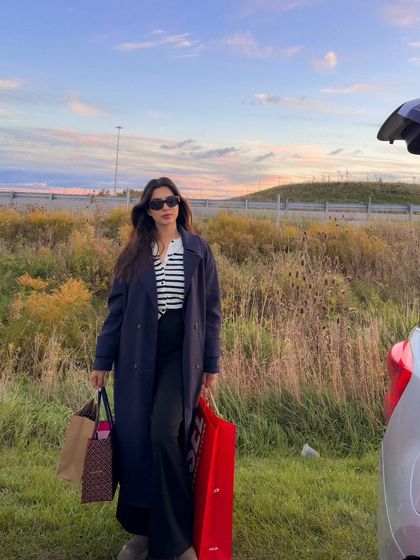 Another shot from the same series, showing a confident pose by the car.