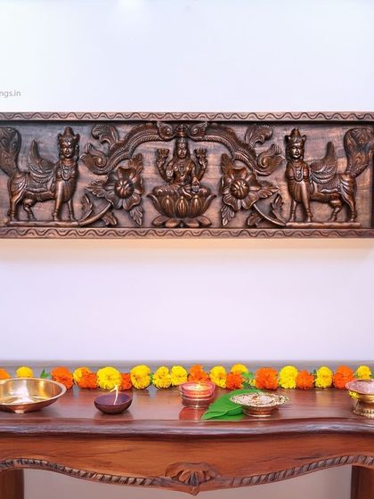 Another setting for the Mahalakshmi and Kamadhenu panel, decorated with fresh flowers for a festive occasion.
