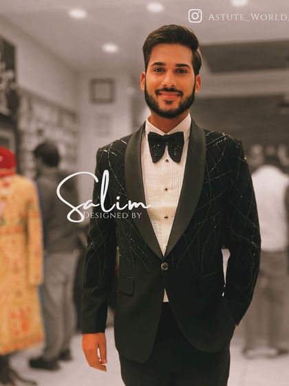 A client in a black velvet tuxedo with a subtle sparkling grid pattern. The look is completed with a matching bow tie for a polished finish.