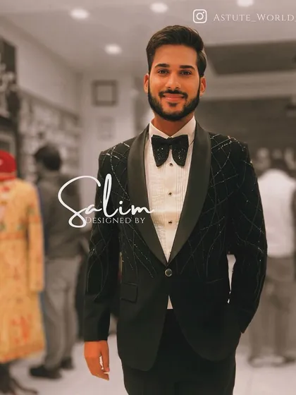 A client in a black velvet tuxedo with a subtle sparkling grid pattern. The look is completed with a matching bow tie for a polished finish.