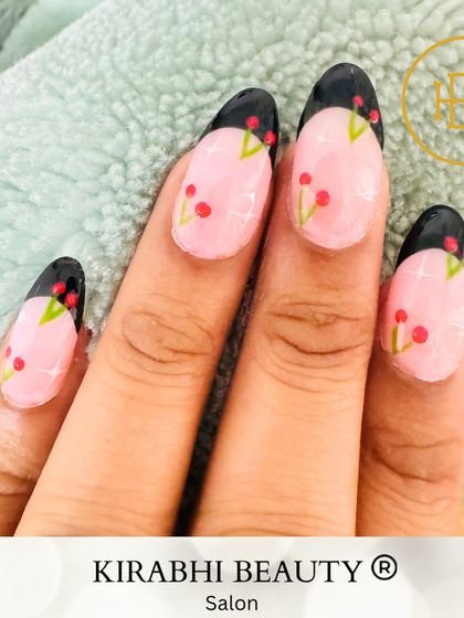 A closer look at the hand-painted cherry French tip nails. Each little cherry is carefully detailed to create a playful and unique design.