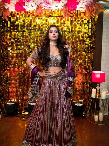 This look is perfect for a sangeet or reception. The client is ready to celebrate in a sparkling lehenga, with dramatic eye makeup and a glowing complexion that catches the light beautifully.