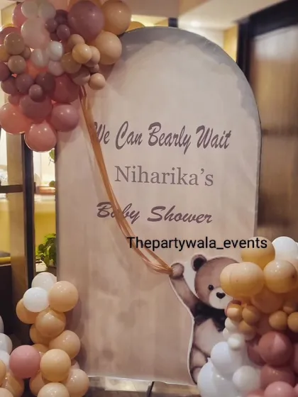 A close-up of the custom "We Can Bearly Wait" backdrop for a teddy bear themed baby shower.