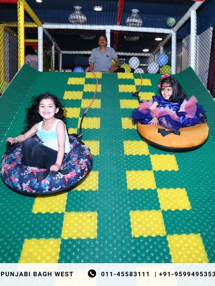 Two friends getting ready to zoom down our popular donut slide, a highlight of any party.