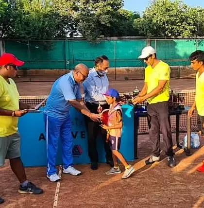 The runner-up of the Under-10 mixed event receives his award from the coaching staff.