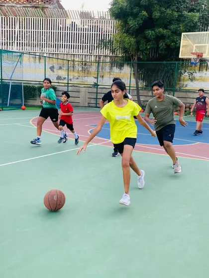A female player dribbles the ball, looking for an opportunity.