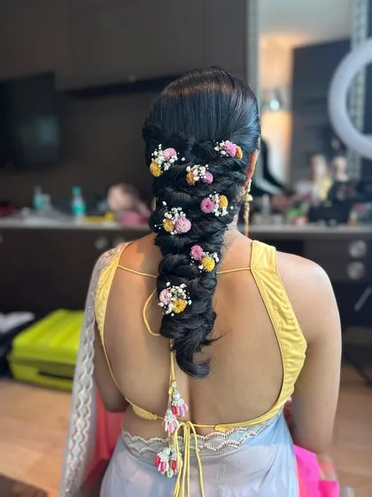 A close-up of the messy braid with a mix of colorful flowers, showing the beautiful texture and detail.