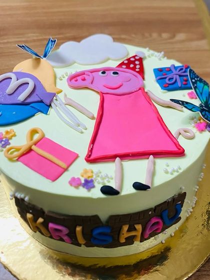 A cute Peppa Pig cake with fondant details, perfect for a young fan's special day.