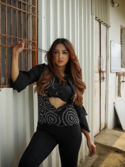 A closer portrait of the model, highlighting her expression and the details of the embroidered vest.