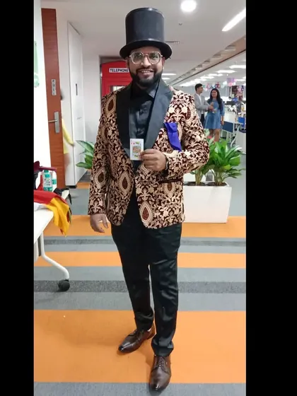 A full-length shot in my classic top hat and tails, holding a single playing card. Magic is the stunning art of surprising your audience, and I'm always ready for the show.