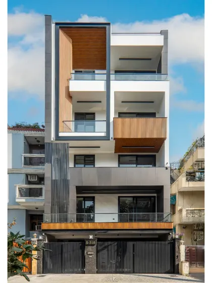 Our completed facade project in Greater Kailash 2, Delhi. This 300 sq. yard elevation is a symphony of texture and depth, using a robust C-channel framing system, wooden finish elements, and sleek aluminum fluted panels.