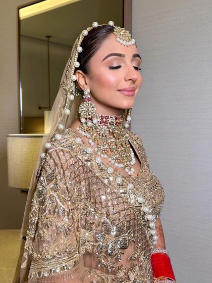 A serene shot of Udita. The soft pink eyeshadow and glowing skin give her an ethereal and angelic look on her wedding day.