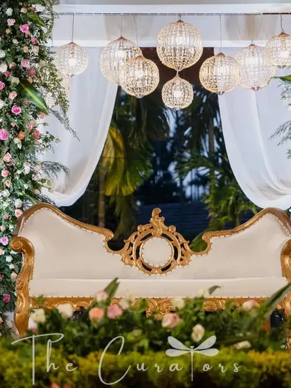 For this reception, we designed a stage of modern elegance. A vintage-inspired sofa, cascading florals, and soft, glowing chandeliers came together to create a romantic and sophisticated focal point for the evening.