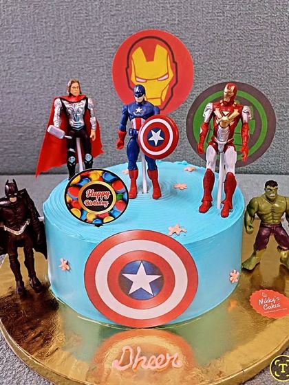Here is another take on the popular Avengers theme, this time on a single-tier cake. It's a great option for smaller parties and includes figurines of Thor, Captain America, Iron Man, Batman, and the Hulk.